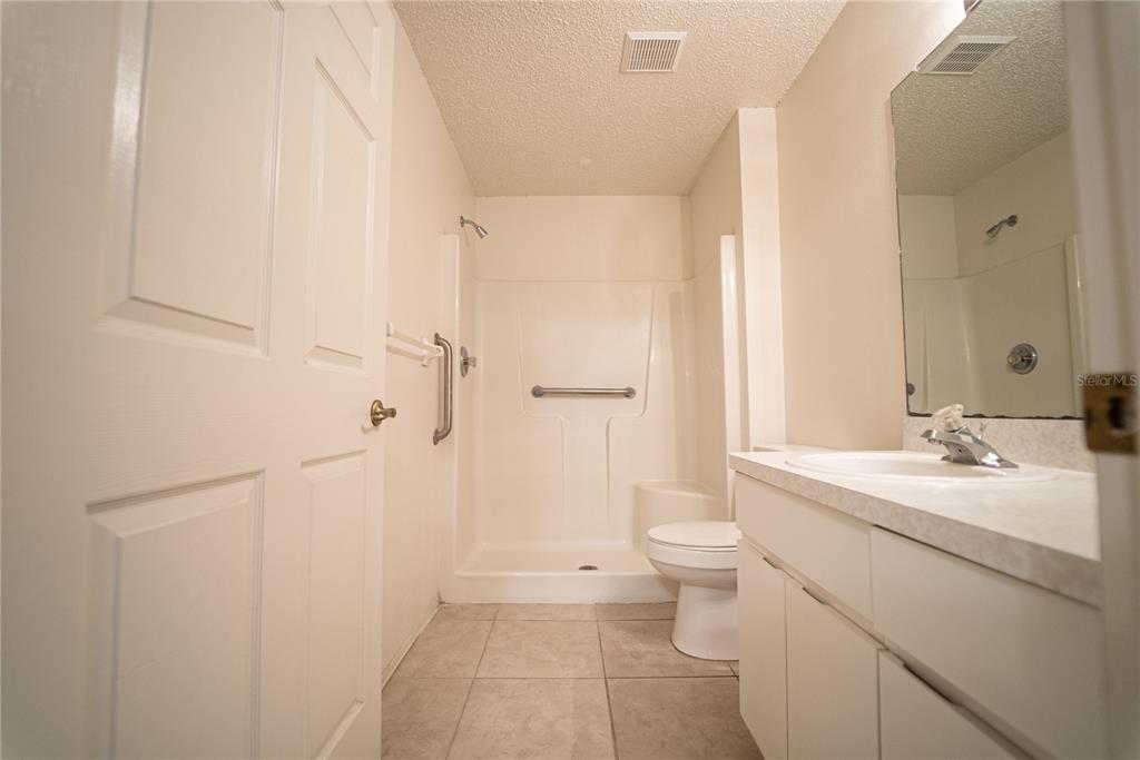 4150 Portillo Road, Unit 5 Spring Hill, FL 34608 - Photo 22 of 25 a bathroom with a sink a toilet and shower