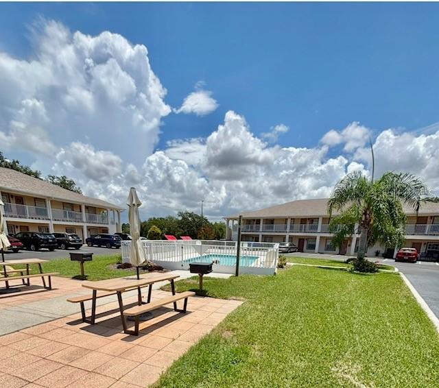 4150 Portillo Road, Unit 5 Spring Hill, FL 34608 - Photo 3 of 25 a swimming pool with outdoor seating and a garden