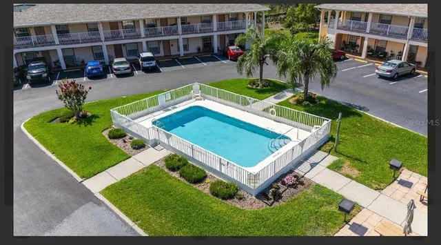 a view of a house with pool porch and sitting area
