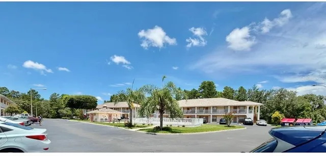 a view of a street with cars parked