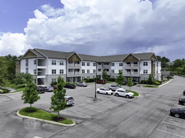 a car parked in front of a white house