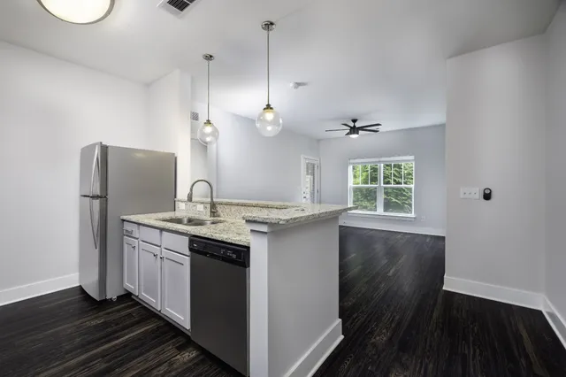a kitchen with a sink and refrigerator
