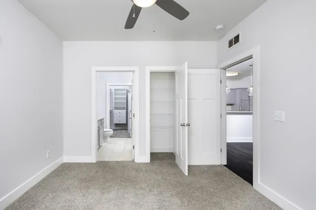 an empty room with a bathroom and a sink