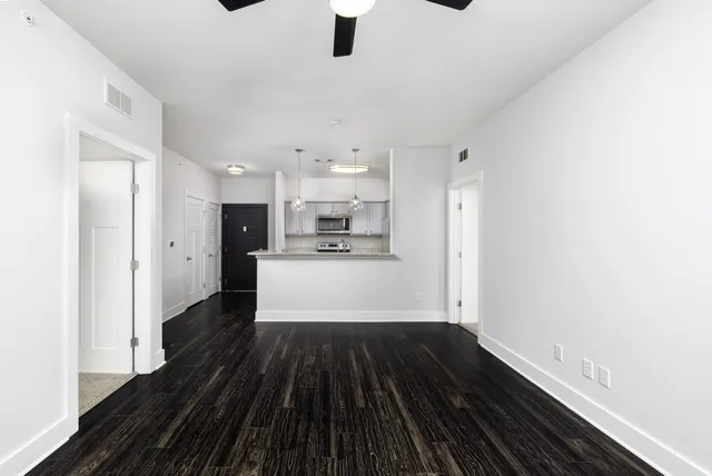 a view of kitchen with sink and refrigerator