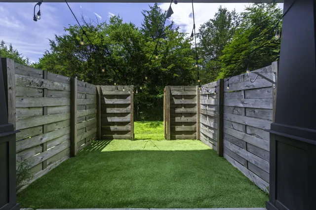 a view of a wooden fence and trees