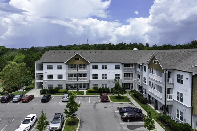 an aerial view of multiple houses with a city street