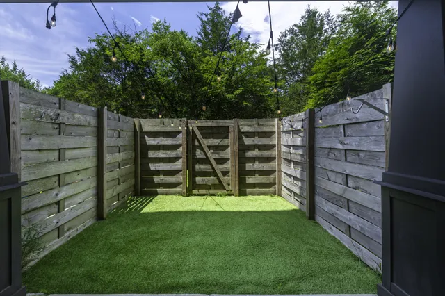 a view of a wooden fence and trees