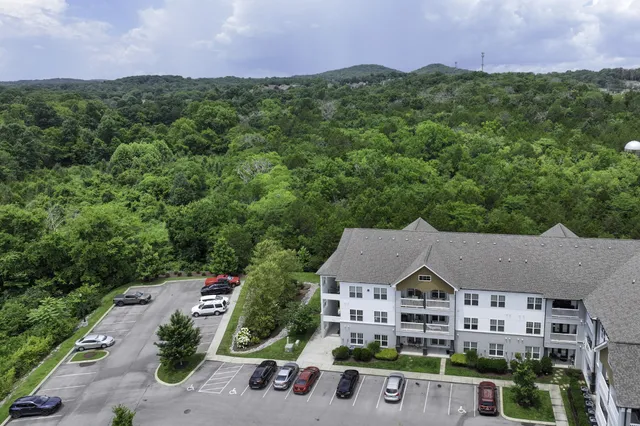 an aerial view of multiple houses with a yard