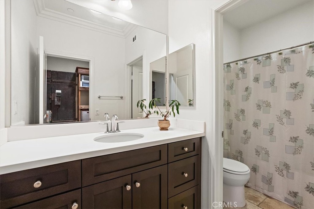 3152 Vista Terrace Riverside, CA 92503 - Photo 41 of 55 a bathroom with a double vanity sink toilet and a mirror