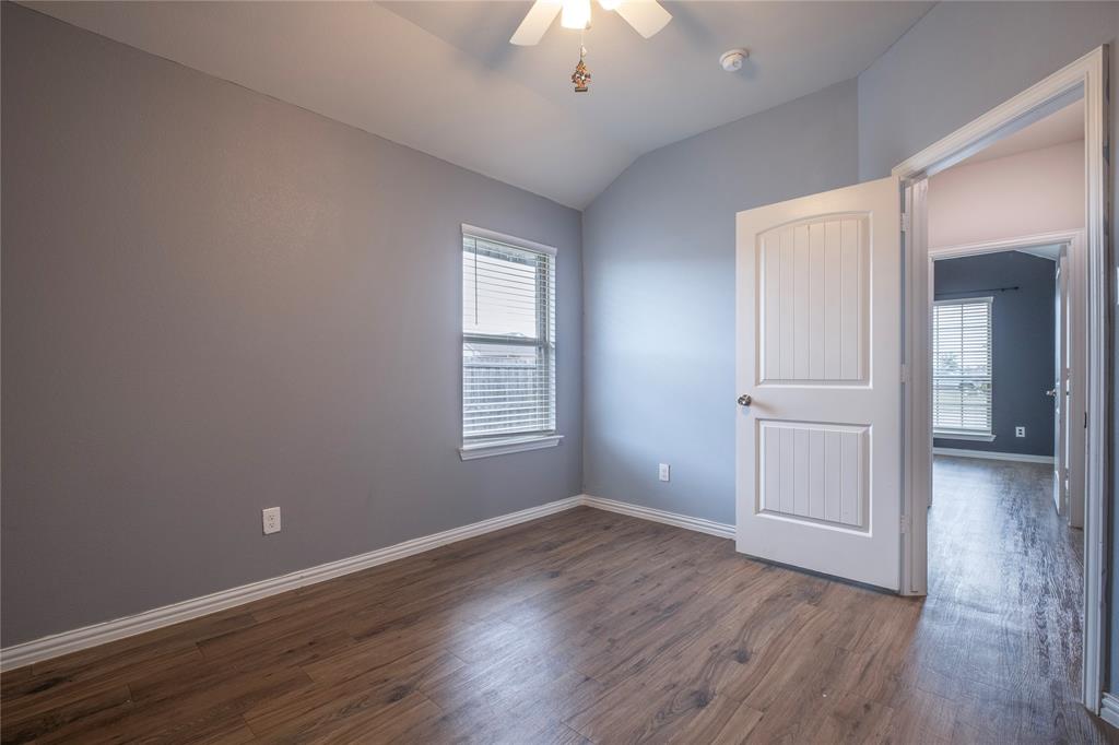 106 Spring Crest Street Mabank, TX 75147 - Photo 11 of 22 an empty room with wooden floor and windows