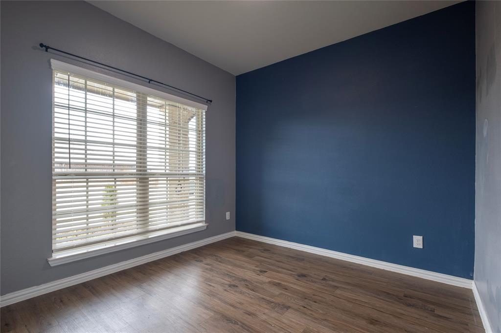 106 Spring Crest Street Mabank, TX 75147 - Photo 12 of 22 a view of an empty room with wooden floor and a window