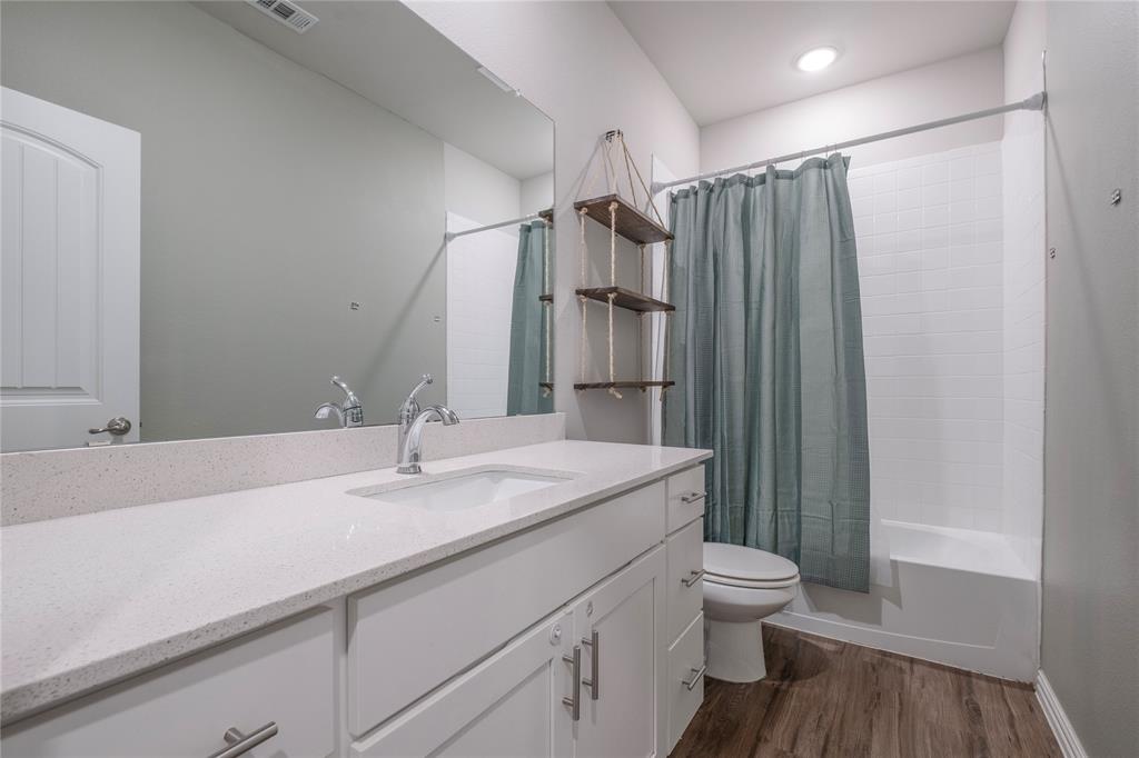 106 Spring Crest Street Mabank, TX 75147 - Photo 17 of 22 a bathroom with a sink a toilet and shower