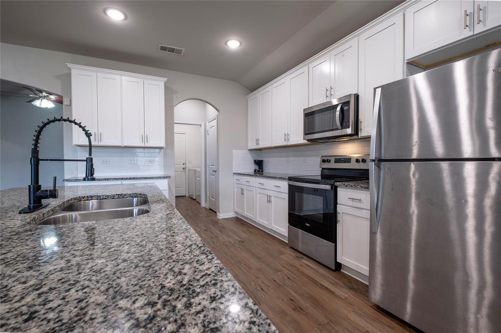 106 Spring Crest Street Mabank, TX 75147 - Photo 7 of 22 a kitchen with stainless steel appliances granite countertop a refrigerator sink and stove