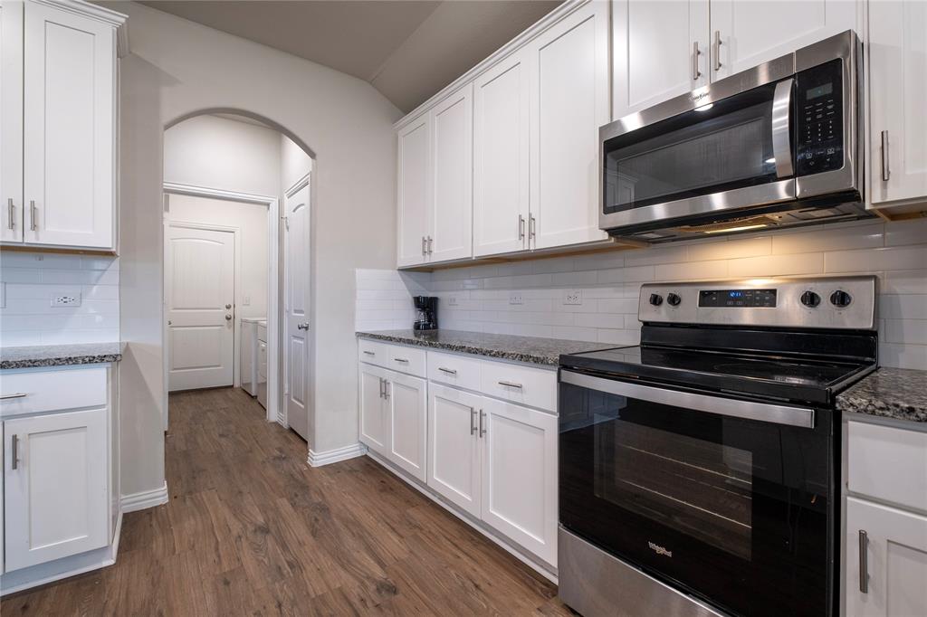 106 Spring Crest Street Mabank, TX 75147 - Photo 8 of 22 a kitchen with stainless steel appliances a stove microwave and sink