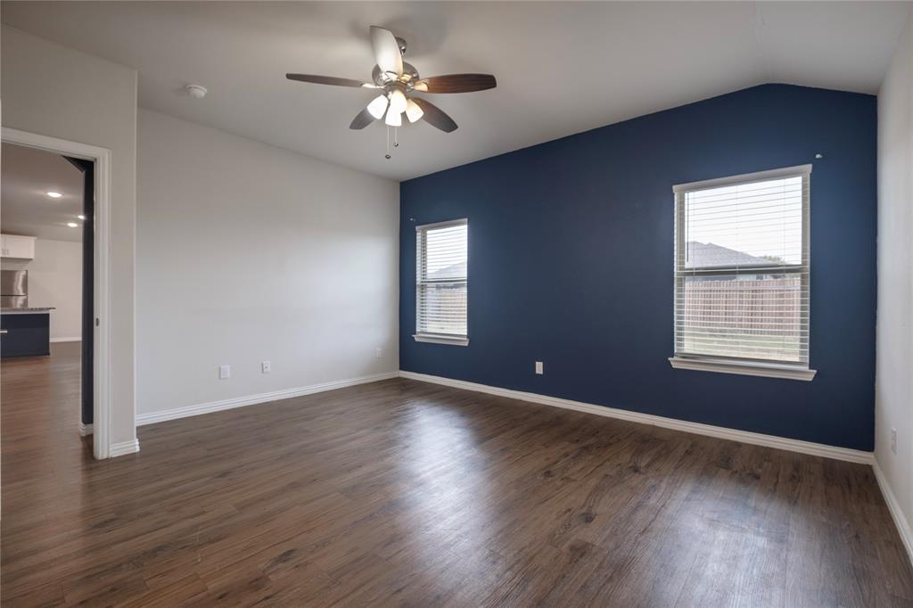106 Spring Crest Street Mabank, TX 75147 - Photo 10 of 22 a view of an empty room with a window and wooden floor