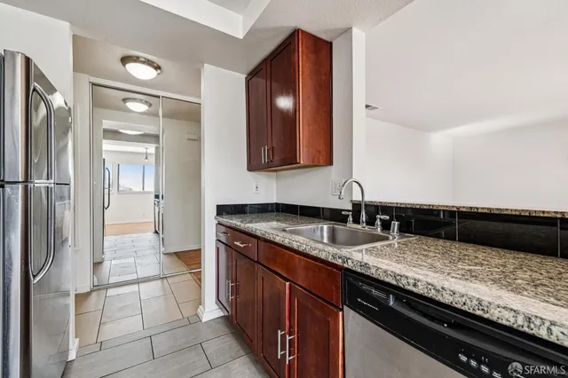 a kitchen with a sink and a refrigerator