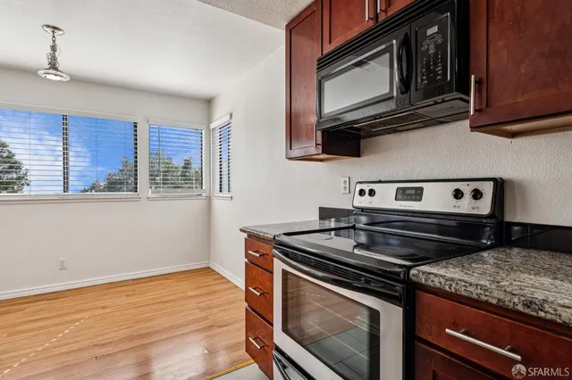a stove top oven sitting inside of a kitchen