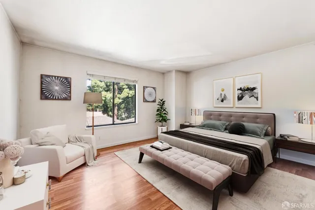 a bedroom with furniture and a large window