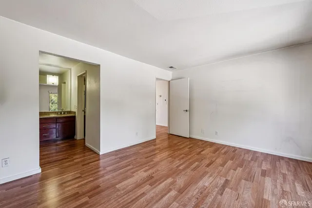 a view of an empty room and wooden floor