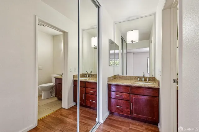 a spacious bathroom with a granite countertop sink and a mirror