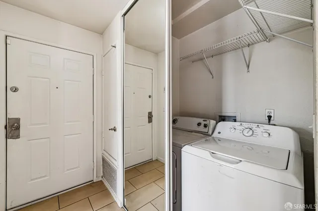 a view of storage and utility room with washer and dryer