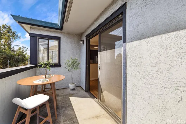 a view of a room with a table and chairs