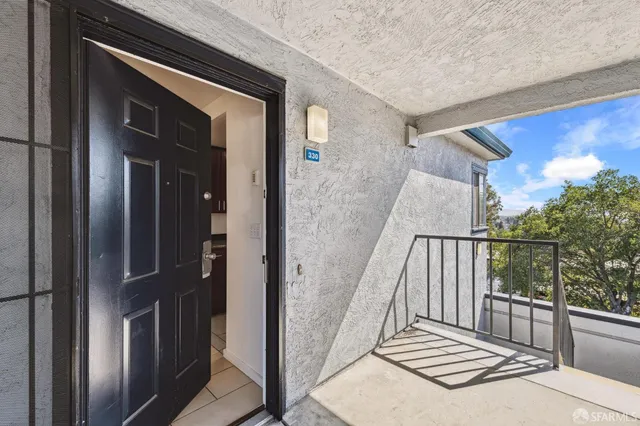 a view of a balcony with wooden floor and fence