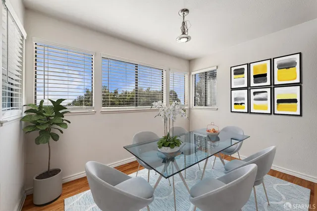a dining room with furniture and potted plants