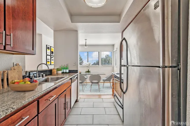 a kitchen with sink refrigerator and stove