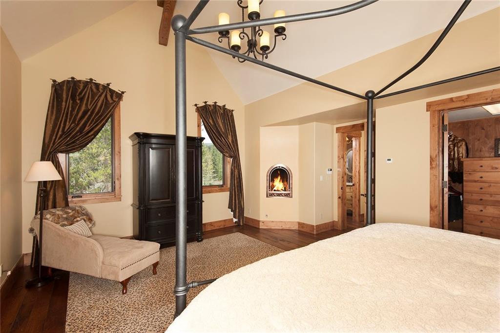 10 Wolf Rock Road Keystone, CO 80435 - Photo 12 of 25 a bedroom with a bed a couch and a chandelier