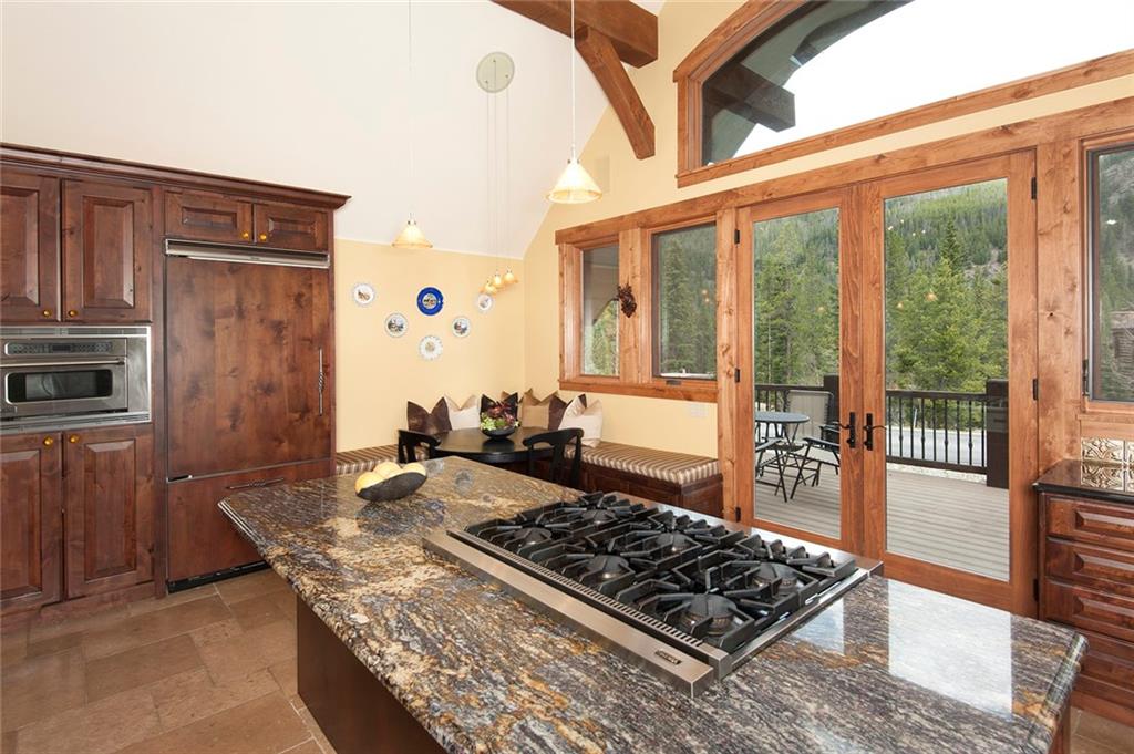 10 Wolf Rock Road Keystone, CO 80435 - Photo 9 of 25 a kitchen with stainless steel appliances granite countertop a stove a sink and a refrigerator