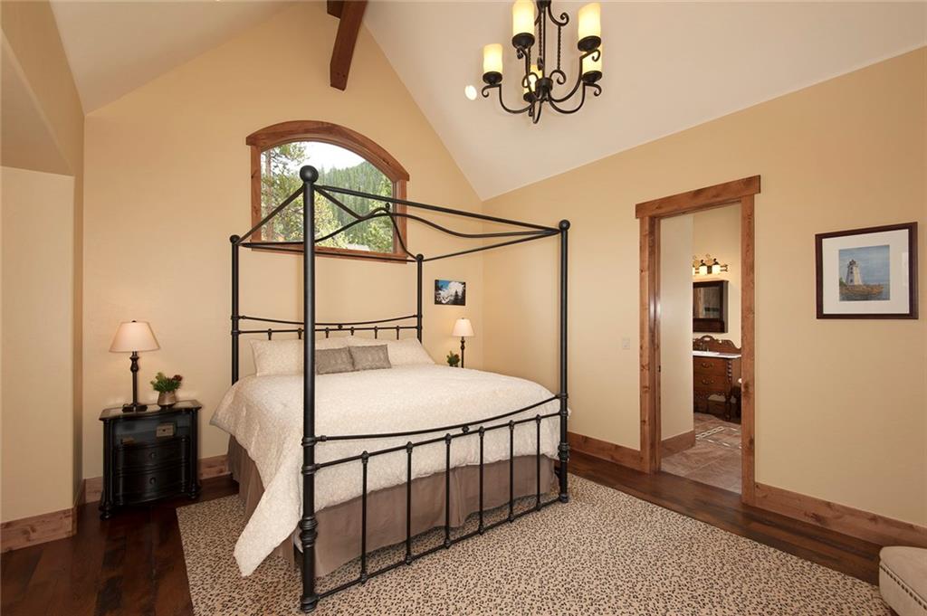10 Wolf Rock Road Keystone, CO 80435 - Photo 10 of 25 a bedroom with a bed and a chandelier
