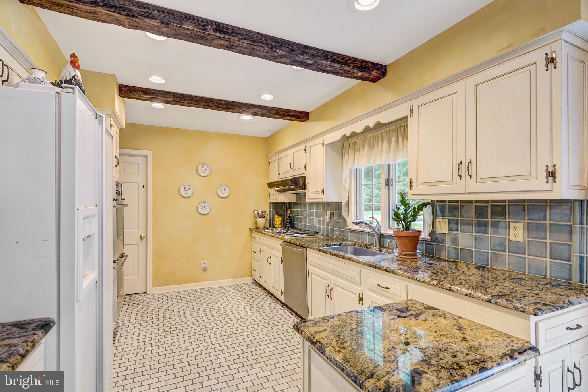 741 Campwoods Road Villanova, PA 19085 - Photo 17 of 48 a kitchen with stainless steel appliances granite countertop a sink stove and refrigerator