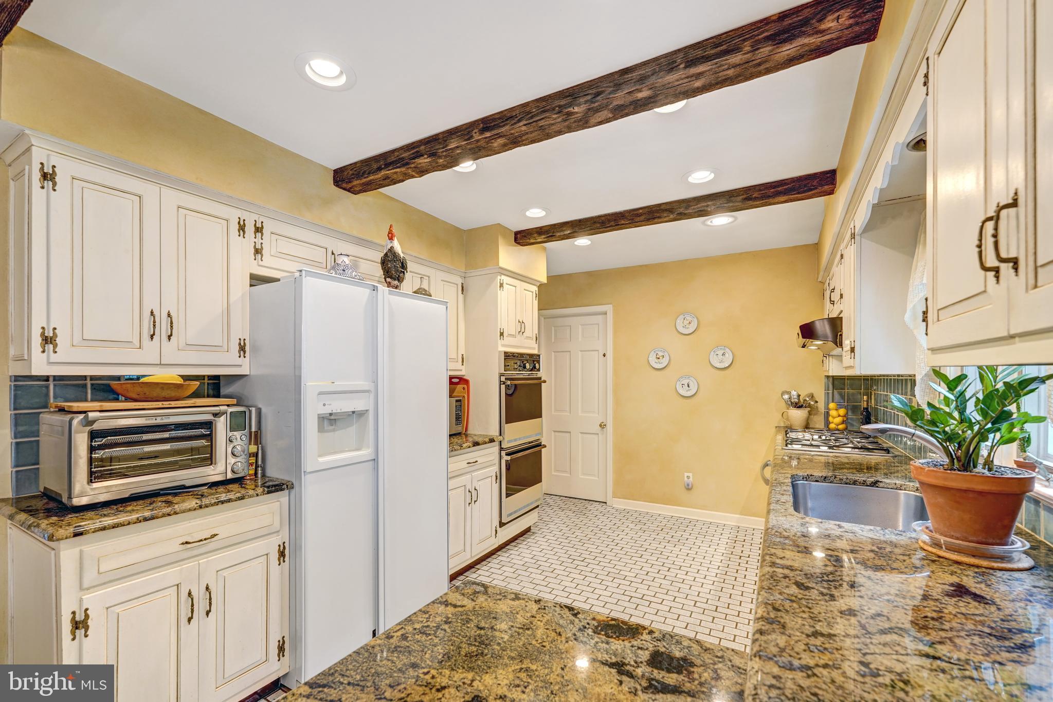 741 Campwoods Road Villanova, PA 19085 - Photo 19 of 48 a kitchen with a refrigerator and a stove top oven