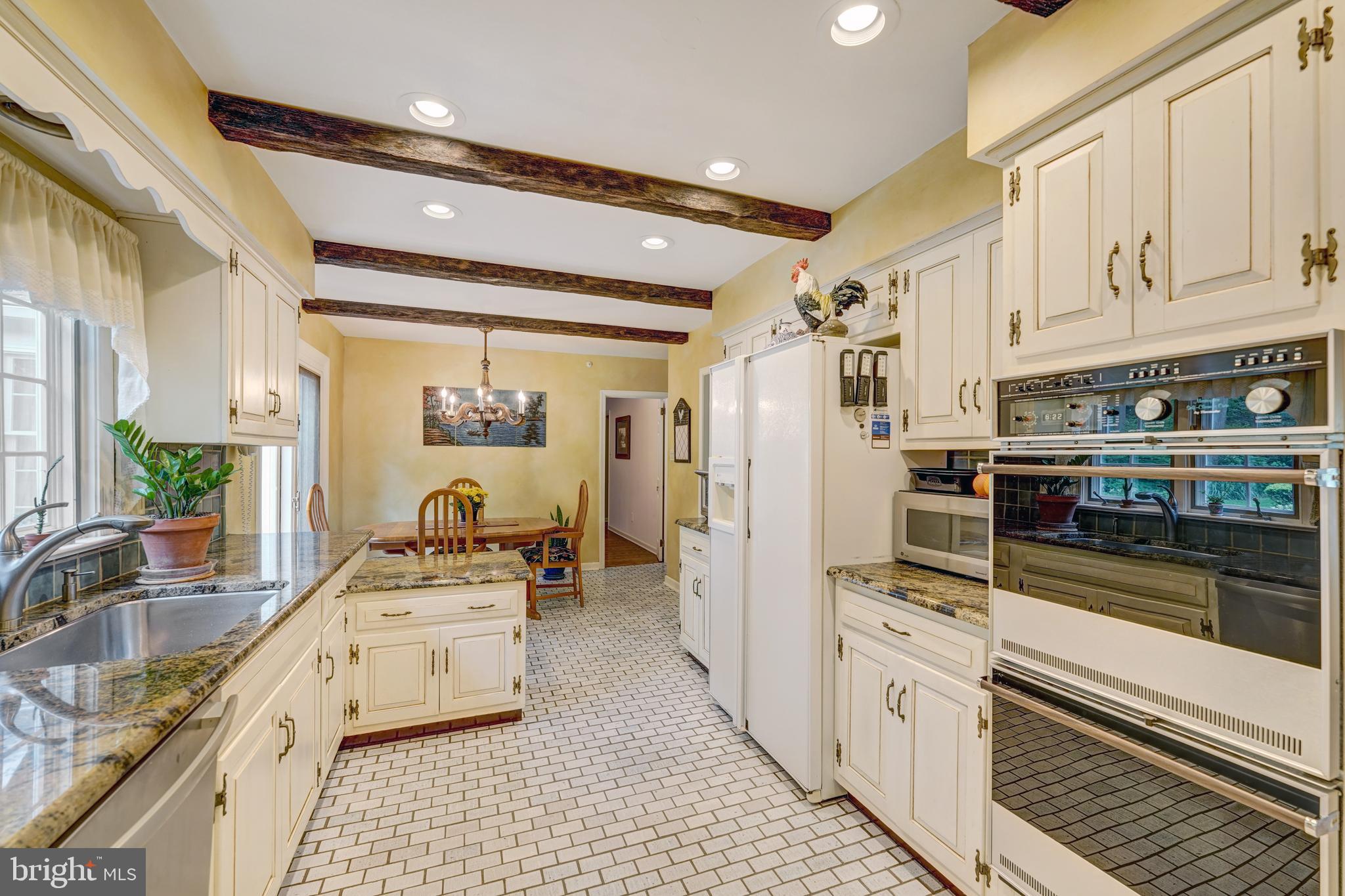 741 Campwoods Road Villanova, PA 19085 - Photo 20 of 48 a kitchen with stainless steel appliances a sink a stove a refrigerator and cabinets