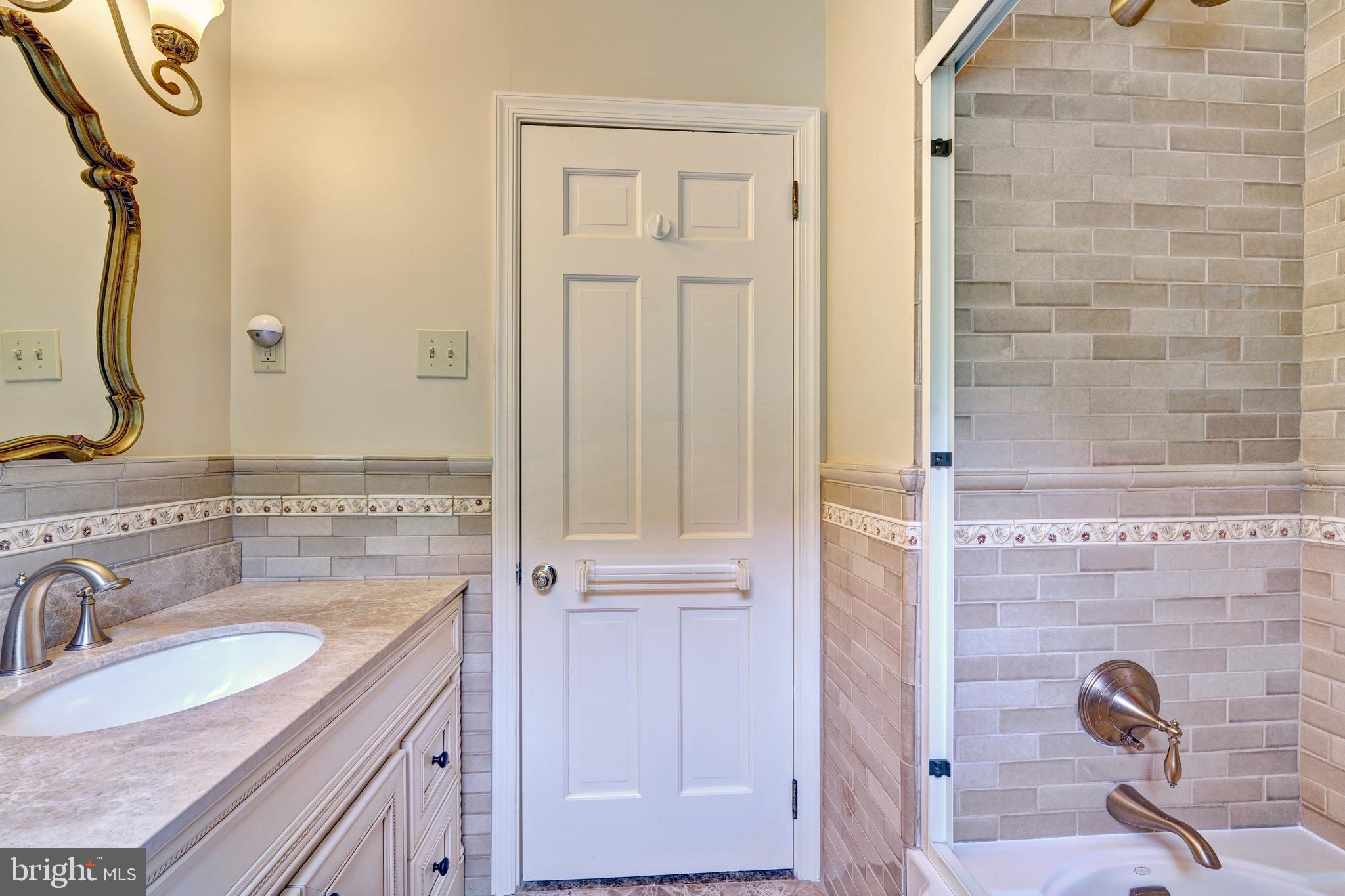 741 Campwoods Road Villanova, PA 19085 - Photo 27 of 48 a bathroom with a granite countertop sink vanity mirror and shower