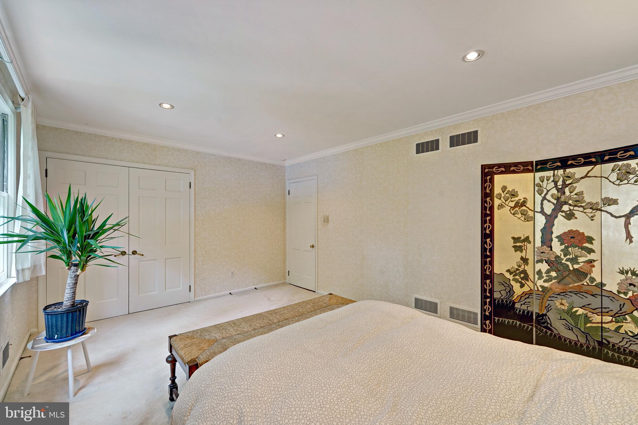 741 Campwoods Road Villanova, PA 19085 - Photo 33 of 48 a bedroom with a large bed and a potted plant