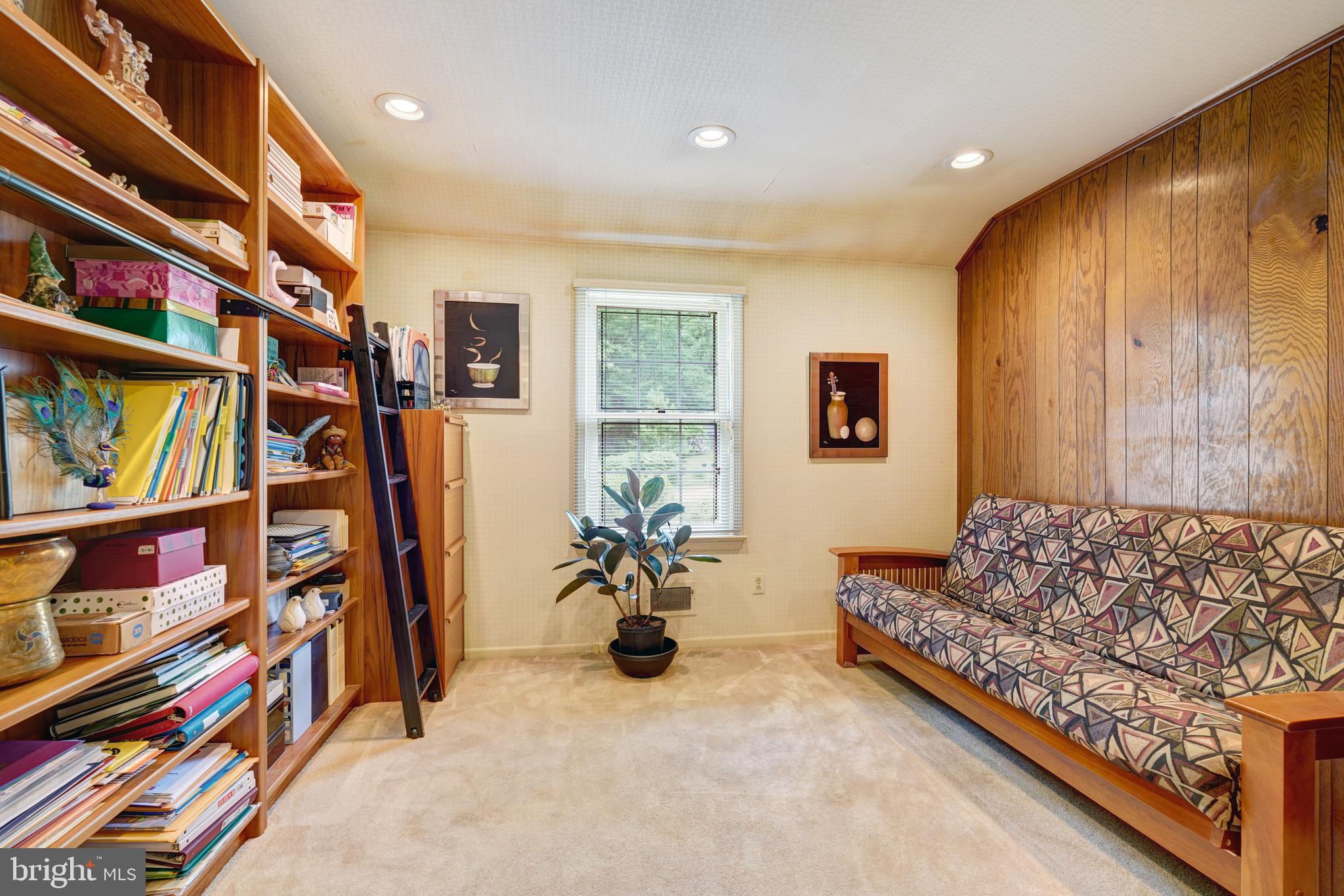 741 Campwoods Road Villanova, PA 19085 - Photo 38 of 48 a living room with lots of furniture and a book shelf