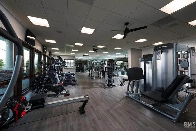 a large kitchen with a counter top space a sink stainless steel appliances and cabinets