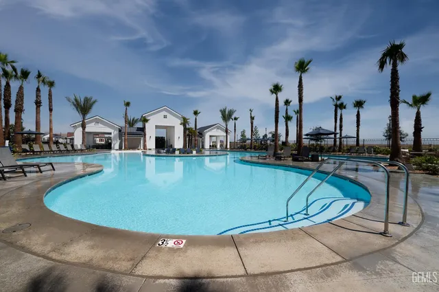 a view of a swimming pool with outdoor seating