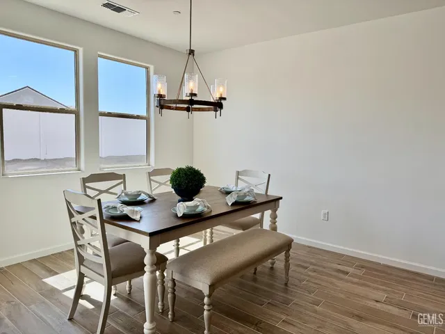 a view of a workspace with furniture and window