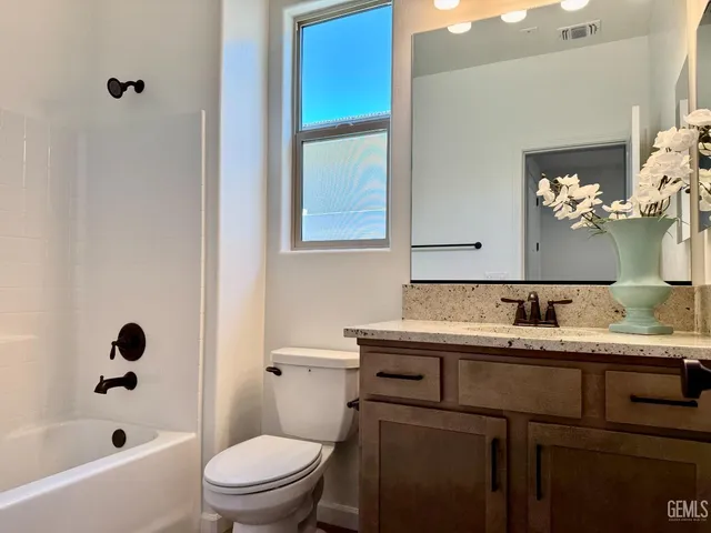 a bathroom with a sink a toilet and bathtub