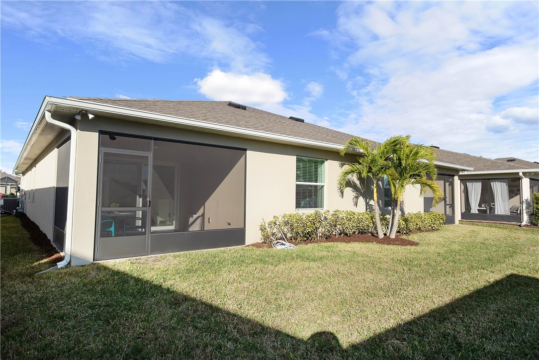6187 Red Maple Manor Vero Beach, FL 32966 - Photo 25 of 31 a front view of a house with garden