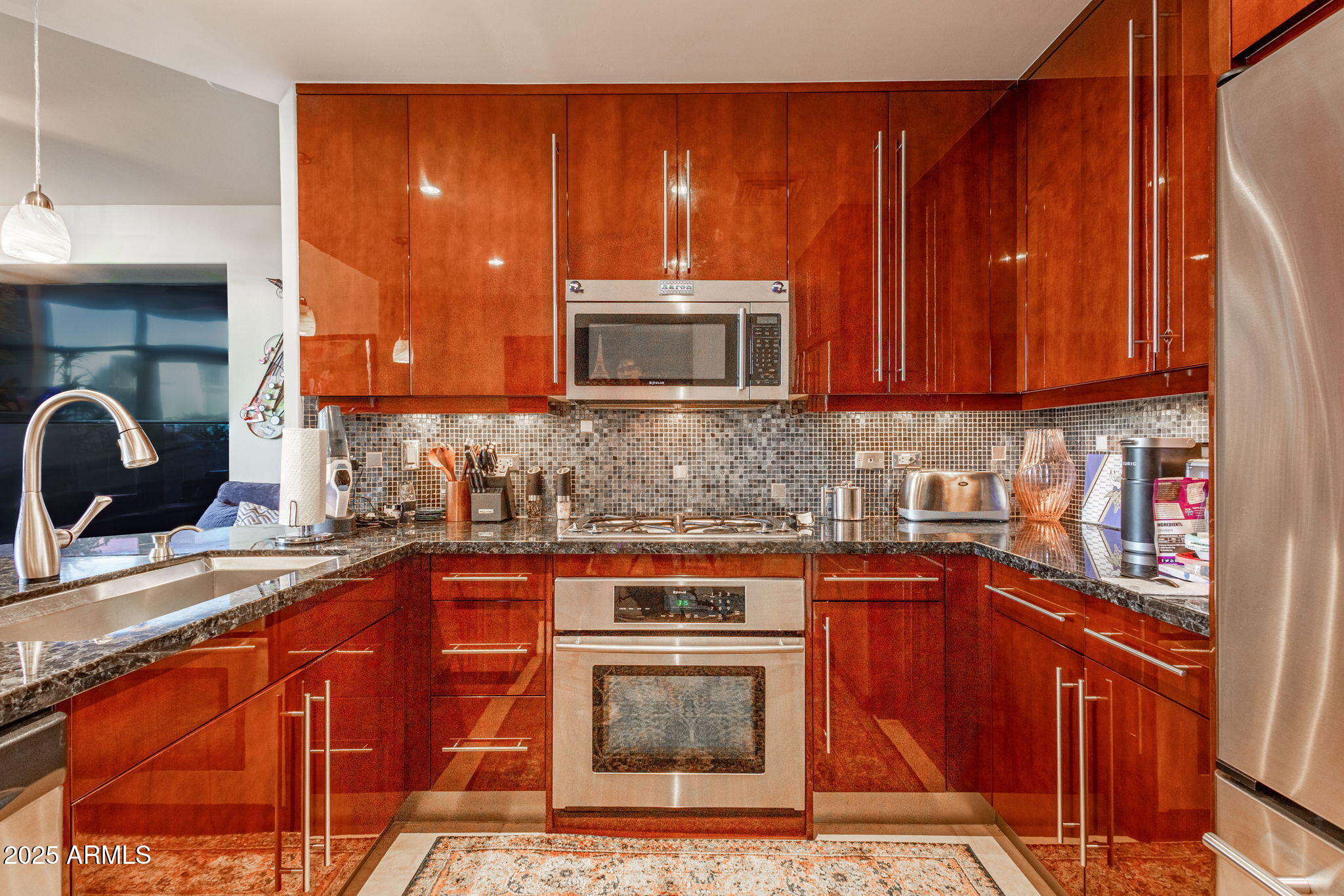 140 East Rio Salado Parkway, Unit 411 Tempe, AZ 85281 - Photo 7 of 21 a kitchen with stainless steel appliances granite countertop a stove a sink and a microwave