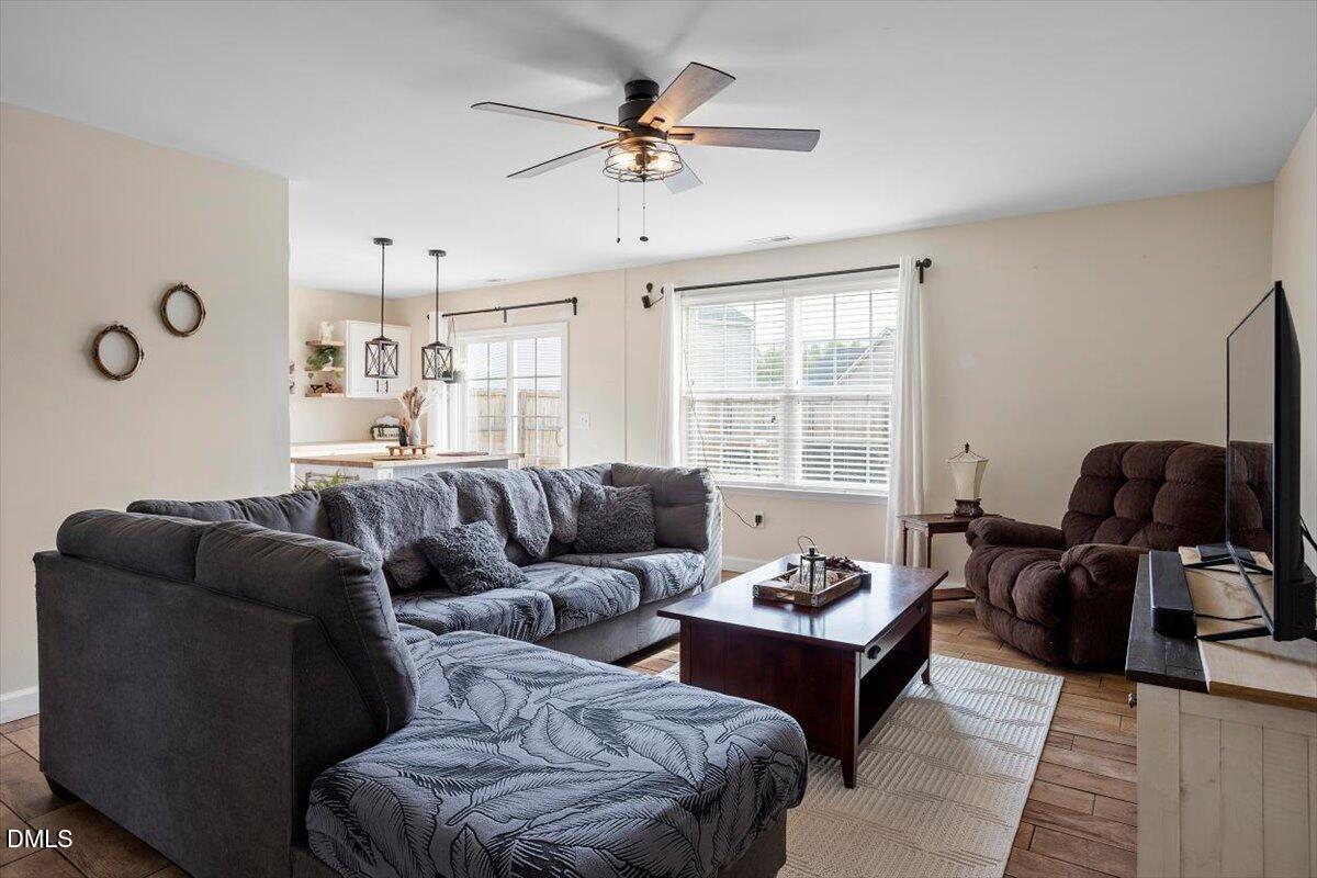 205 Battery Way Bunnlevel, NC 28323 - Photo 9 of 37 a living room with furniture ceiling fan and a window