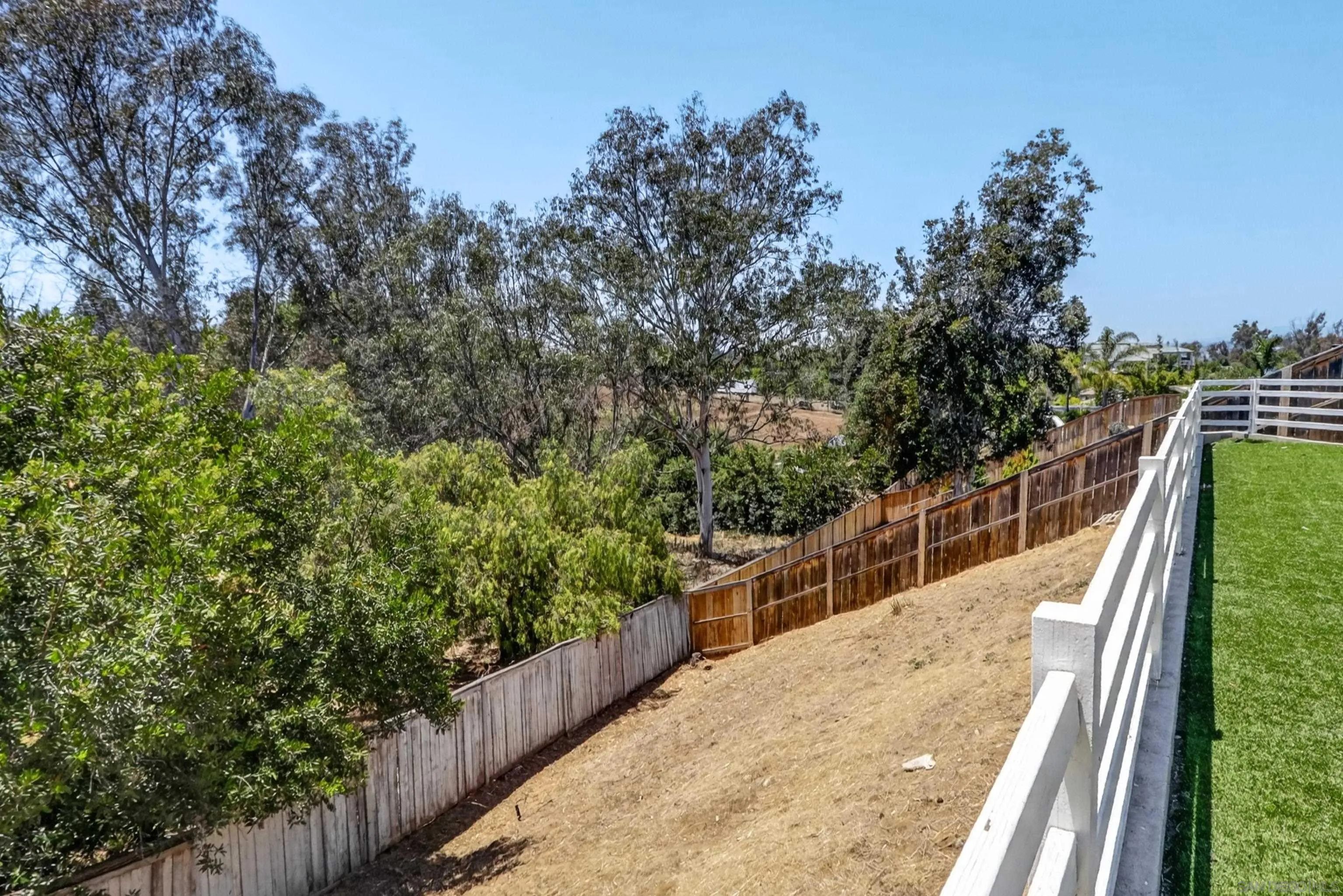 1432 Belmont Park Road Oceanside, CA 92057 - Photo 12 of 54 a view of a balcony with wooden floor and fence