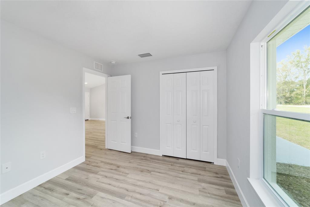 3467 Southwest 150th Court Ocala, FL 34481 - Photo 26 of 35 a view of an empty room with wooden floor and a window