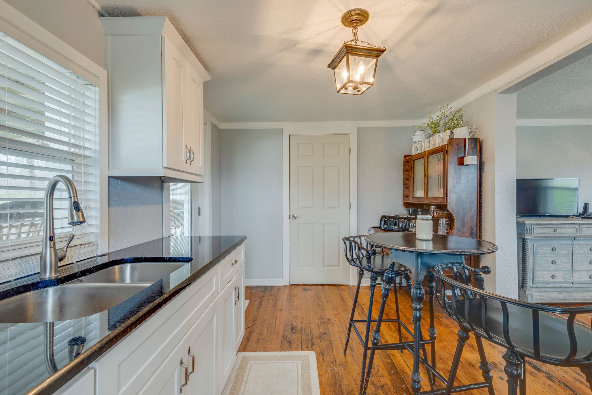 7606 Pewitt Road Franklin, TN 37064 - Photo 12 of 28 a kitchen with stainless steel appliances granite countertop a sink dishwasher and cabinets with wooden floor