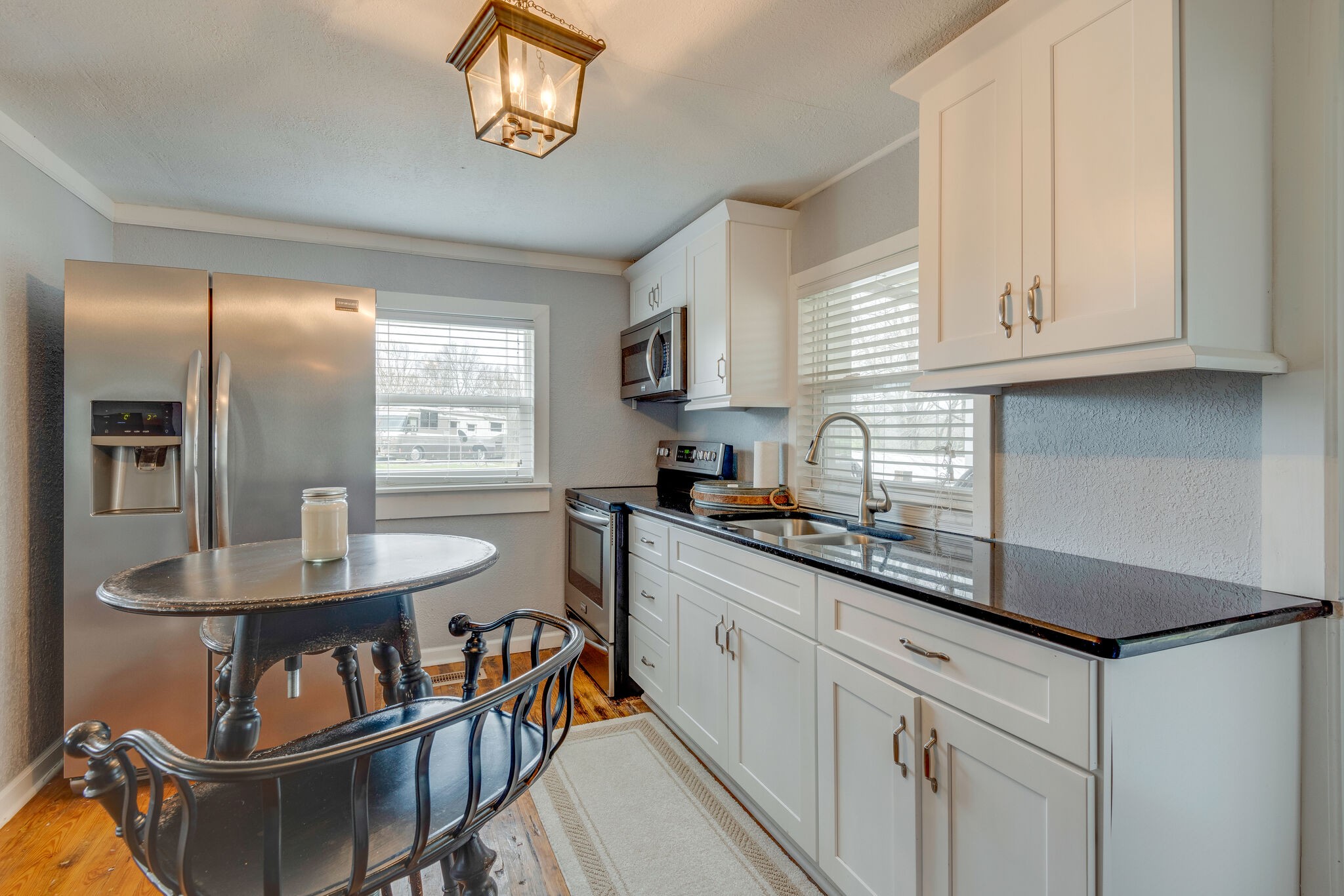 7606 Pewitt Road Franklin, TN 37064 - Photo 15 of 28 a kitchen with cabinets a sink and a stove