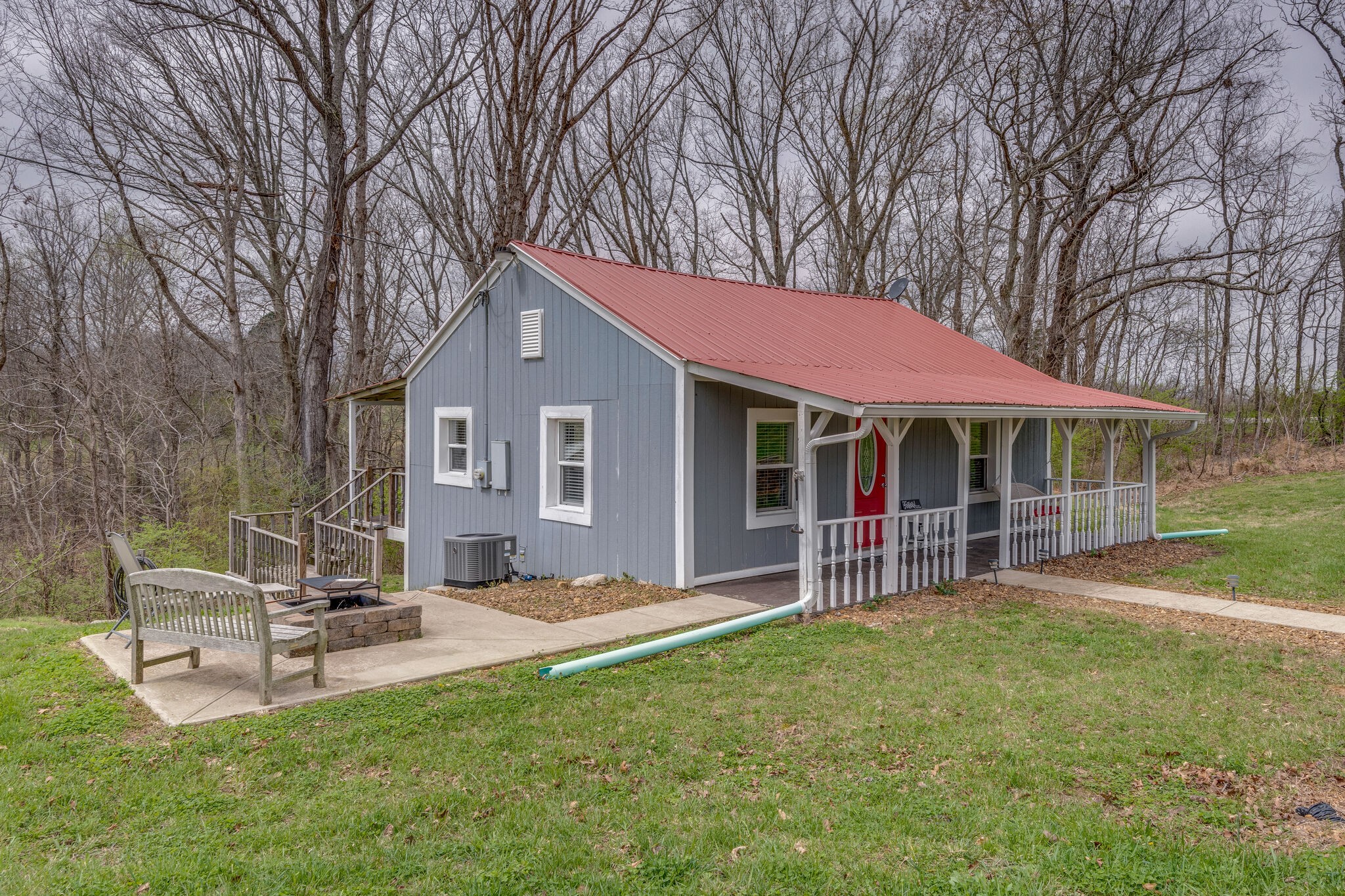 7606 Pewitt Road Franklin, TN 37064 - Photo 3 of 28 a front view of a house with a garden and trees